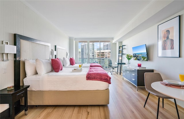 bedroom featuring light hardwood / wood-style floors and expansive windows