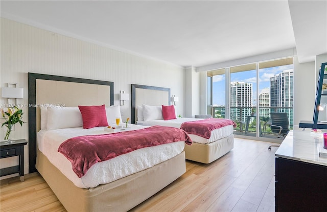 bedroom with access to outside and light hardwood / wood-style floors