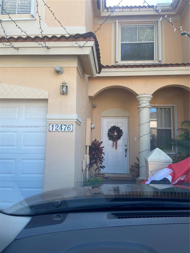 doorway to property featuring a garage