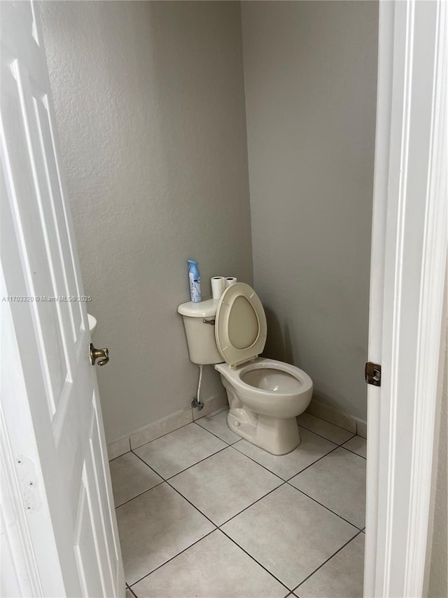 bathroom featuring tile patterned flooring and toilet