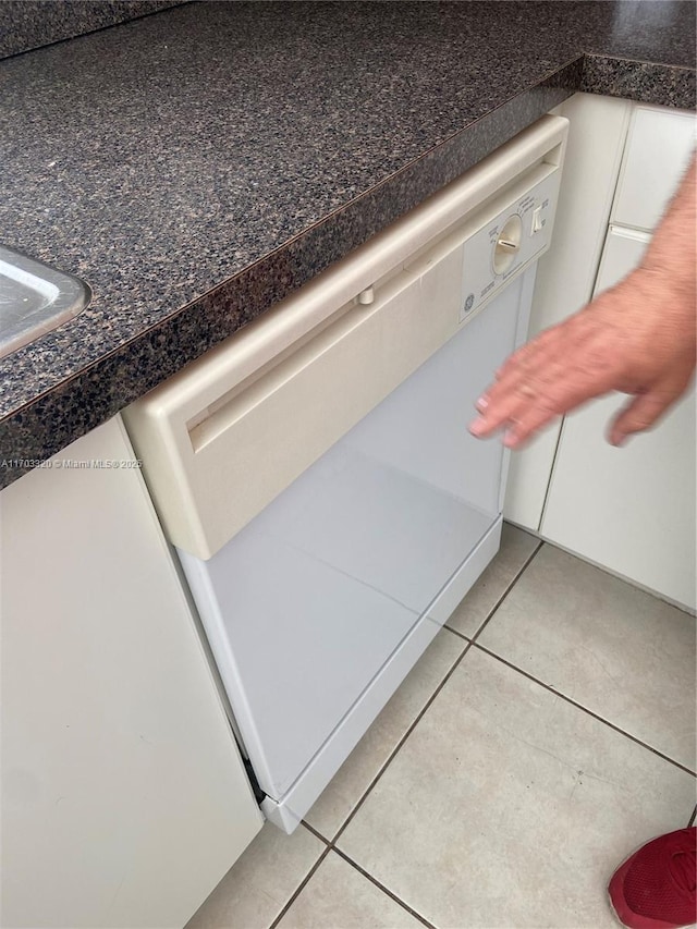 interior details featuring white cabinetry and dishwasher