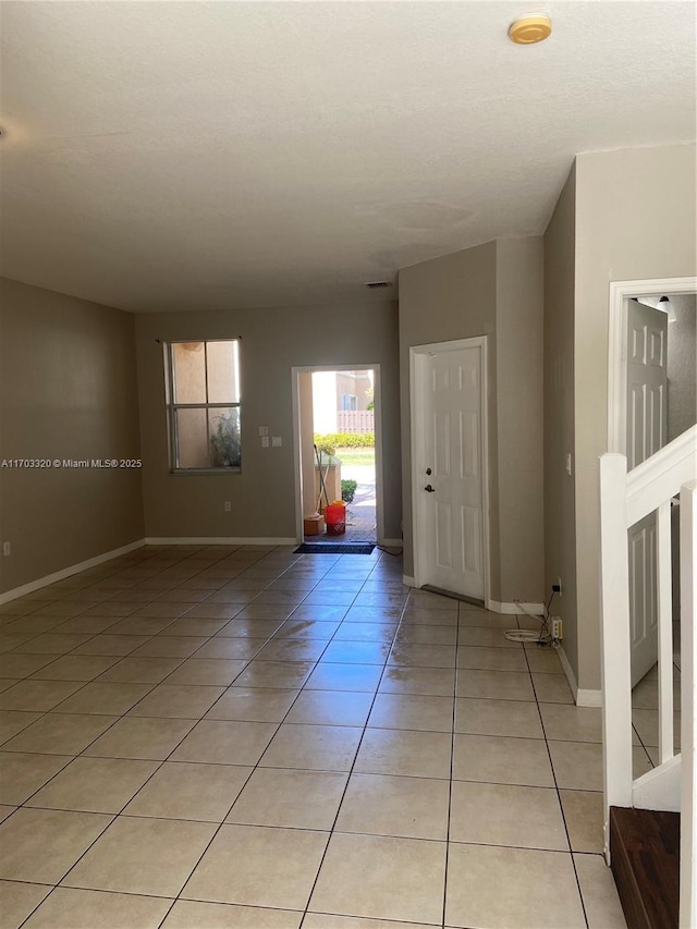 entryway with light tile patterned floors