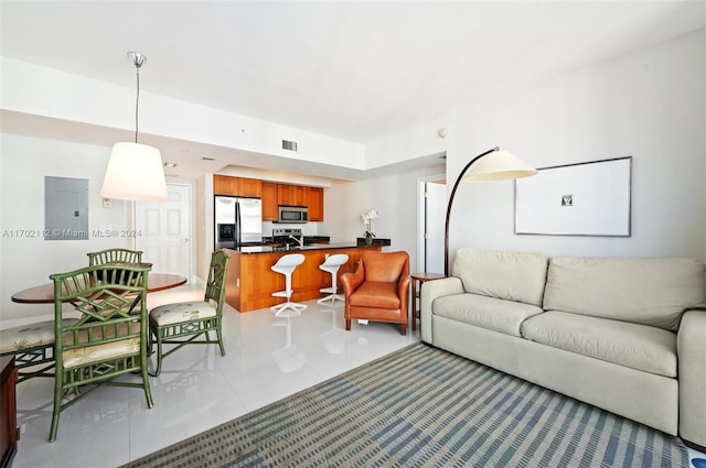 tiled living room with sink and electric panel