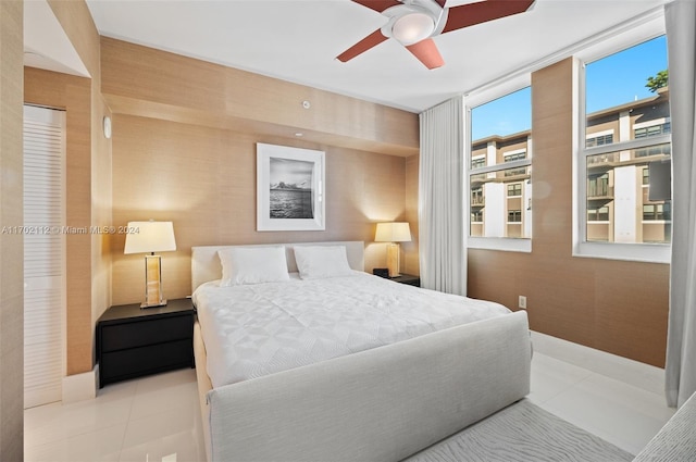 bedroom with ceiling fan and light tile patterned floors