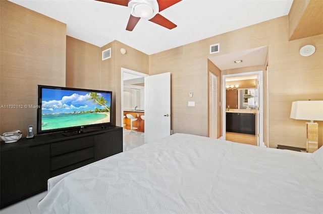 bedroom featuring ceiling fan and ensuite bath