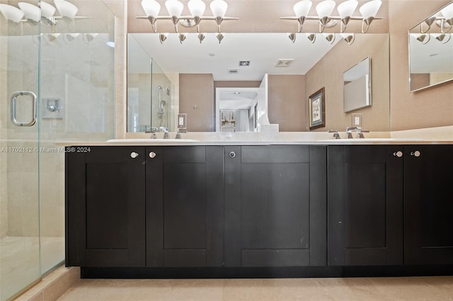 bathroom featuring vanity, tile patterned floors, and walk in shower