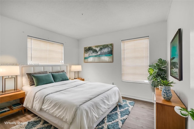 bedroom with wood-type flooring and a textured ceiling