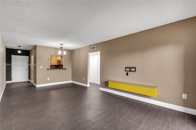 interior space with a textured ceiling and a notable chandelier