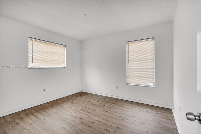 spare room featuring light hardwood / wood-style floors