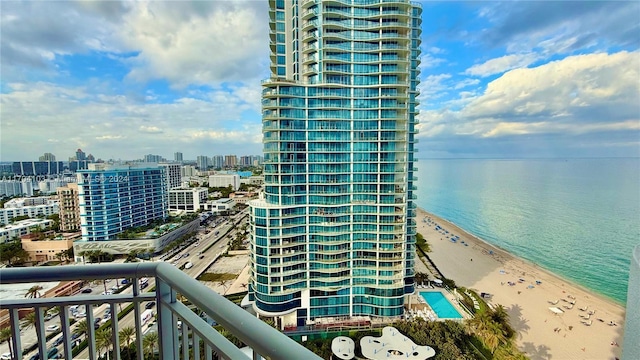 balcony featuring a beach view and a water view