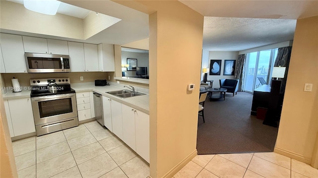 17375 Collins Ave Unit 2406, Sunny Isles Beach, FL 33160 - kitchen featuring stainless steel appliances, light countertops, and light tile patterned flooring