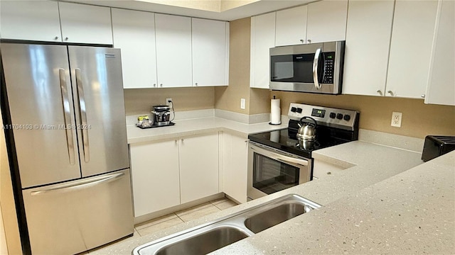 kitchen featuring sink, white cabinetry, and stainless steel appliances