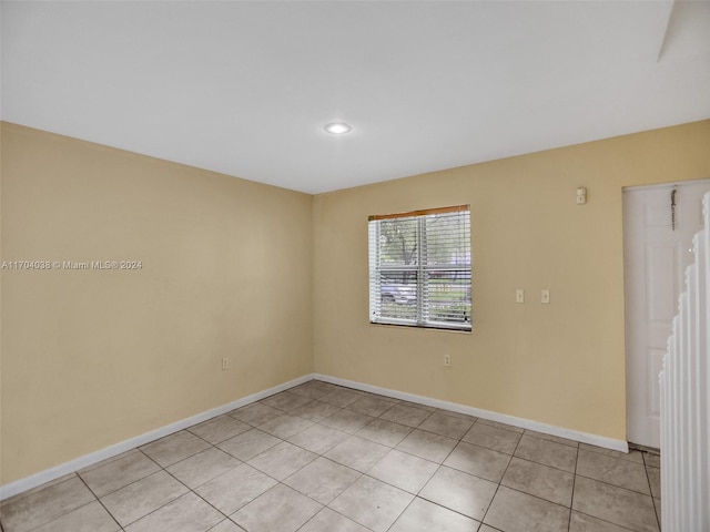 empty room with light tile patterned flooring