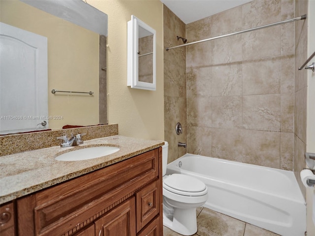 full bathroom featuring tile patterned floors, vanity, tiled shower / bath combo, and toilet