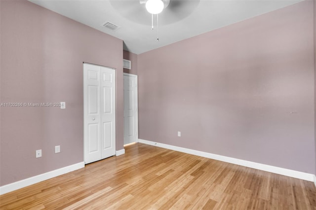 unfurnished bedroom with ceiling fan, lofted ceiling, and hardwood / wood-style flooring