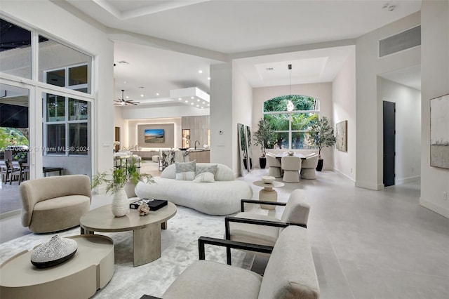 living room with ceiling fan and concrete floors