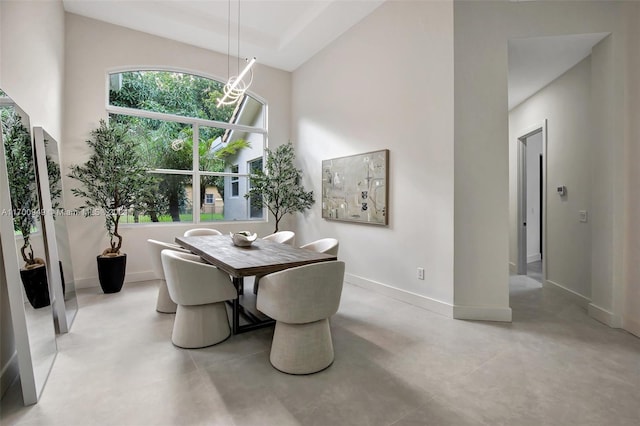 dining area featuring a high ceiling