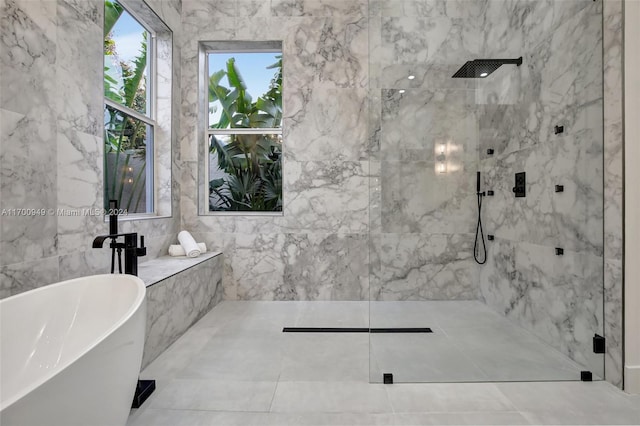 bathroom featuring tile walls and shower with separate bathtub