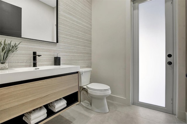 bathroom featuring tile patterned flooring, vanity, and toilet