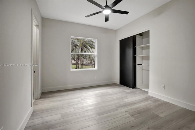 unfurnished bedroom with a closet, light hardwood / wood-style flooring, and ceiling fan