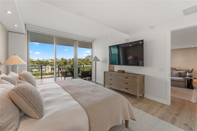 bedroom featuring recessed lighting, wood finished floors, baseboards, access to outside, and floor to ceiling windows