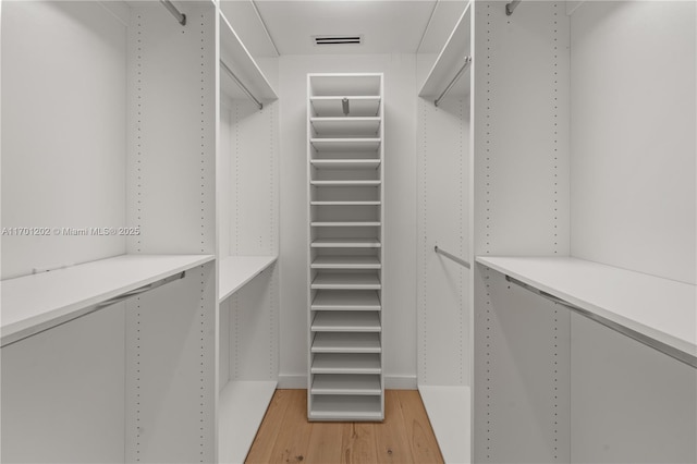 walk in closet featuring light wood finished floors and visible vents