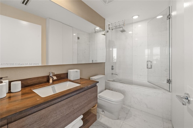 full bathroom featuring marble finish floor, visible vents, toilet, enclosed tub / shower combo, and vanity