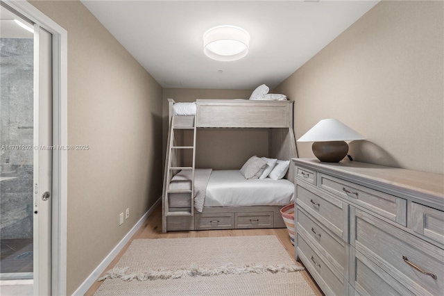 bedroom featuring baseboards and light wood-style floors