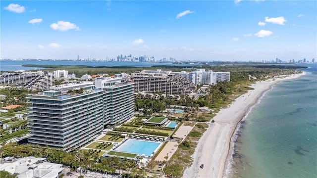 bird's eye view with a city view, a water view, and a beach view