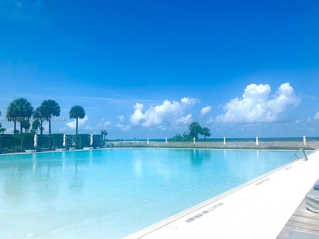 view of pool with a water view