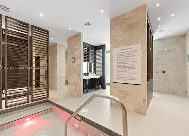 bathroom with recessed lighting, visible vents, tile walls, and tile patterned floors