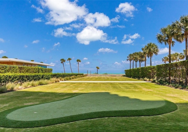 view of community featuring a yard and golf course view