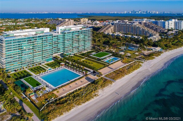 birds eye view of property featuring a beach view and a water view