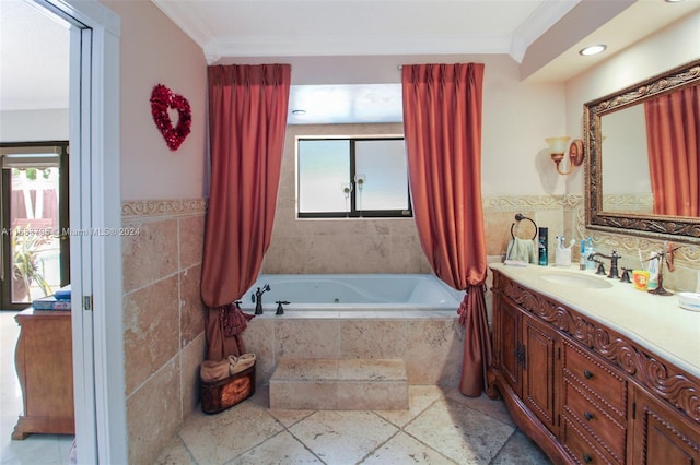 bathroom featuring tiled tub, crown molding, vanity, and tile walls