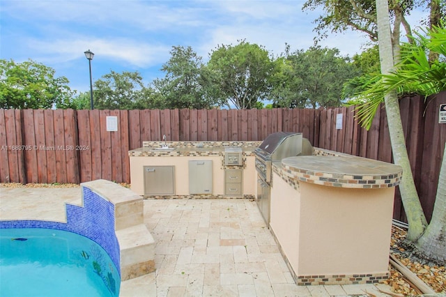 view of patio / terrace featuring grilling area and exterior kitchen