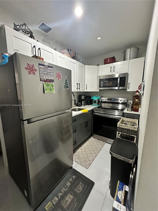 kitchen featuring white cabinetry, stainless steel appliances, and sink