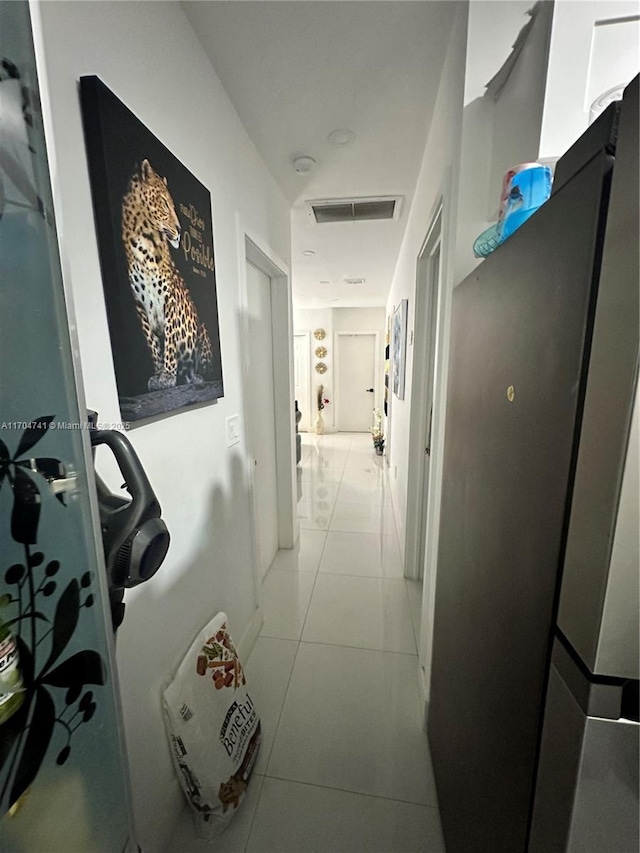 corridor featuring light tile patterned floors