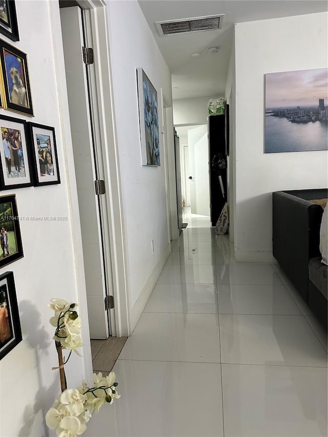 corridor featuring light tile patterned floors