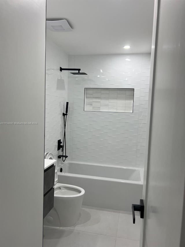 full bathroom with vanity, tiled shower / bath combo, toilet, and tile patterned flooring