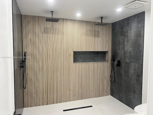 bathroom featuring toilet and tiled shower