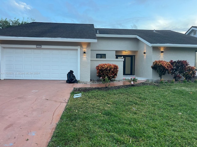 view of front of home featuring a garage and a front lawn