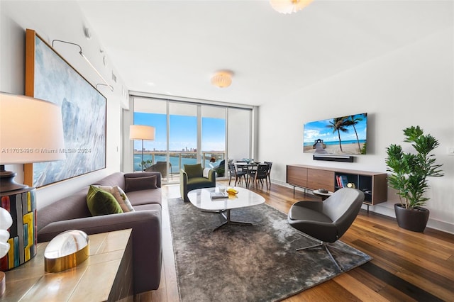 living room featuring hardwood / wood-style flooring and a wall of windows