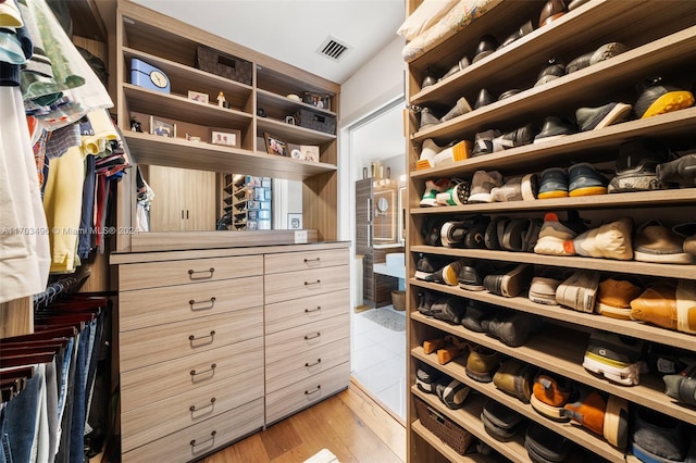 walk in closet featuring light hardwood / wood-style floors