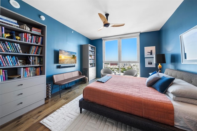 bedroom with wood-type flooring and ceiling fan