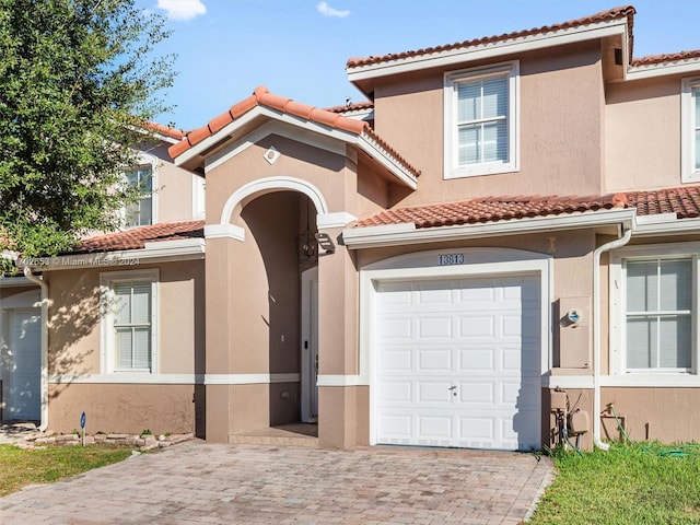 mediterranean / spanish house featuring a garage