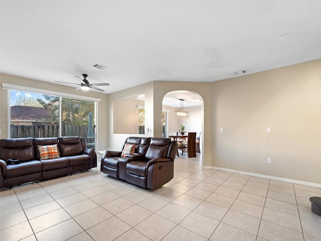 tiled living room featuring ceiling fan