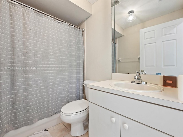 bathroom with tile patterned flooring, vanity, and toilet