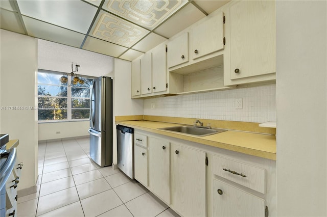 kitchen featuring sink, light tile patterned floors, and appliances with stainless steel finishes