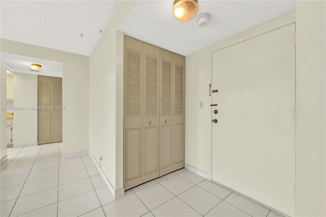 corridor with light tile patterned floors