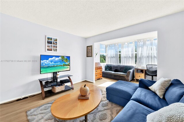 bedroom with hardwood / wood-style flooring and a textured ceiling